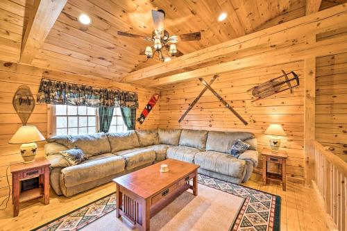 a living room with a couch and a table at 9 Mi to Bretton Woods Carroll Log Cabin with Deck in Carroll