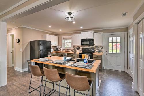 a kitchen with a large island with chairs around it at Cozy Murfreesboro Home with Furnished Patio! in Murfreesboro