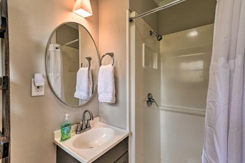 a bathroom with a sink and a mirror and a shower at Cozy Murfreesboro Home with Furnished Patio! in Murfreesboro