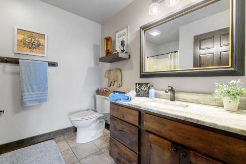 a bathroom with a sink and a toilet and a mirror at Whiskey Hills At Terry Peak in Lead