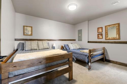a bedroom with two beds and a mirror on the wall at Whiskey Hills At Terry Peak in Lead