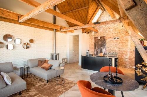 a living room with a table and chairs at Luxe appartementen Havenzicht in Sint Annaland