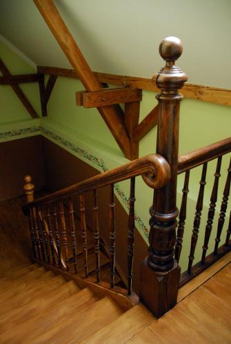 a wooden staircase with a wooden railing in a house at Alte Bahnstation Leipzig (Appartement TWO & ONE) in Leipzig