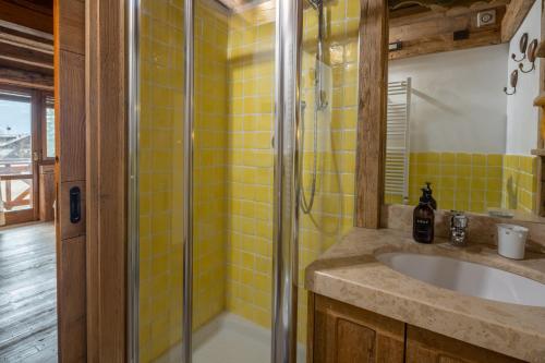 a bathroom with a sink and a glass shower at Cortina Lodge Stunning View R&R in Cortina dʼAmpezzo