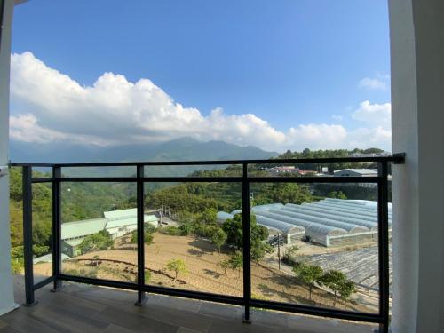 a balcony with a view of a building at 清境依山舞林民宿 in Renai