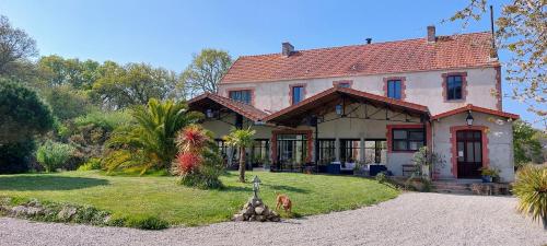 a large house with a yard in front of it at Laiterie de Tocqueville B&B in Tocqueville