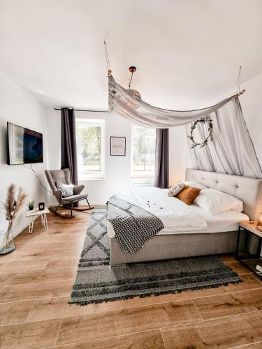 a bedroom with a bed with a canopy at Holiday Home Amélie in Bollendorf