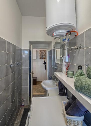 a bathroom with a sink and a toilet and a tub at City Apartment TODOR in Pula