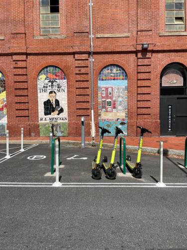 a group of scooters parked in a parking lot at Downtown Home - Close to Topgolf, Ravens Stadium, Orioles Park, UM Baltimore in Baltimore