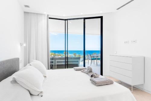 una camera con letto e vista sull'oceano di New Luxury Apartment First Sea Line a Palm-Mar