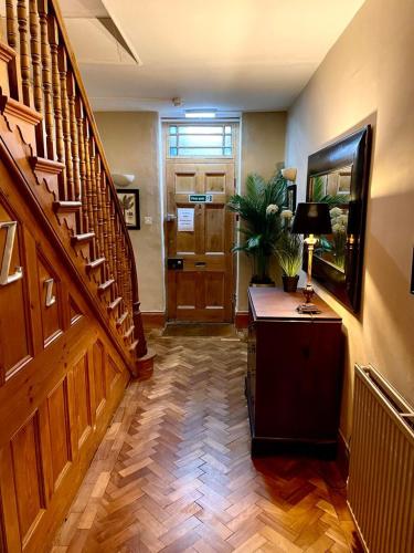 a hallway with stairs and aoyer with a fish tank at Chester House Hotel in Bourton on the Water