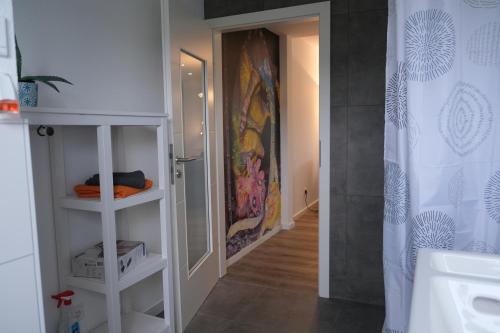 a bathroom with a shower and a shower curtain at FeWo TIMON großzügig modern mit Terrasse ca 50 qm in Hamm