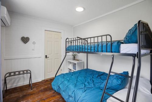 a bedroom with two bunk beds with blue sheets at Charming 4 bedroom farmhouse with large backyard for entertaining in Mountain City