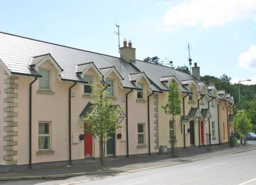 a row of houses on the side of a street at Churchmount Holiday Home Roundwood by Trident Holiday Homes in Wicklow