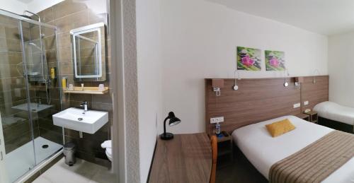 a bathroom with a bed and a sink and a shower at La Buissonnière in Corbigny