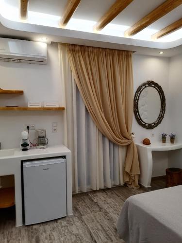 a room with a bed and a mirror at Blue Sky Summer in Naxos Chora