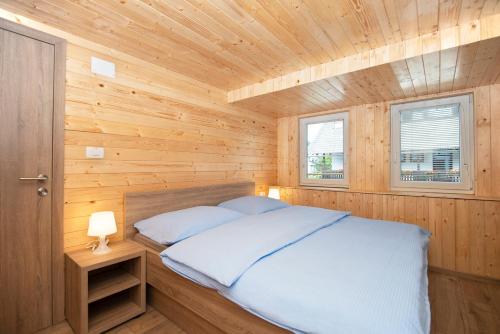 a bedroom with a bed in a wooden cabin at Zotlar House in Bohinj