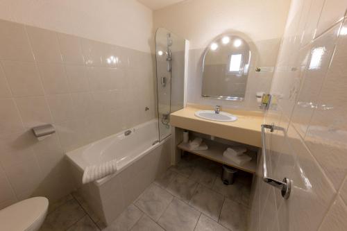 a bathroom with a sink and a toilet and a shower at Hôtel Casa Rossa & Spa in LʼÎle-Rousse