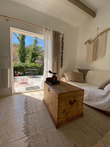 a living room with a bed and a large window at Duplex FACE AU LAC à 600 mètres de la mer in Six-Fours-les-Plages