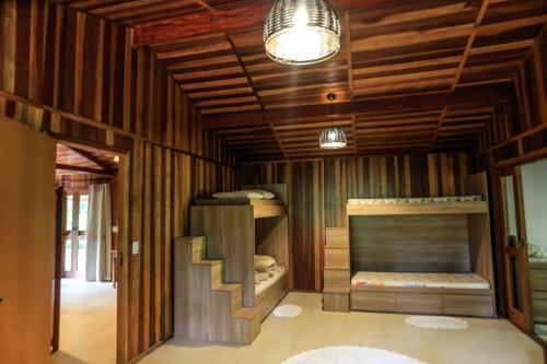 a room with two bunk beds and a fireplace at Sitio Bom Tempo in Miguel Pereira