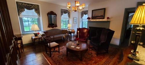 a living room with chairs and a table and a fireplace at General Warren in Malvern