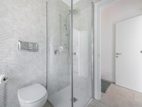 a bathroom with a toilet and a glass shower at Villa Latisa in Terra Mala