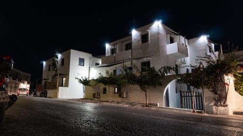 a city street at night with white buildings at Vista Mare in Naousa