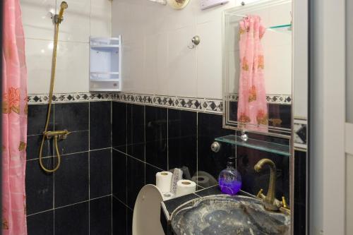 a bathroom with a sink and a toilet and a mirror at Dar Lalla Bouchra in Fez