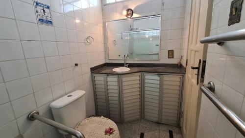 a small bathroom with a sink and a mirror at Aldeia Hostel in Manaus