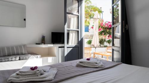 a bedroom with a bed with towels on it at Vista Mare in Naousa