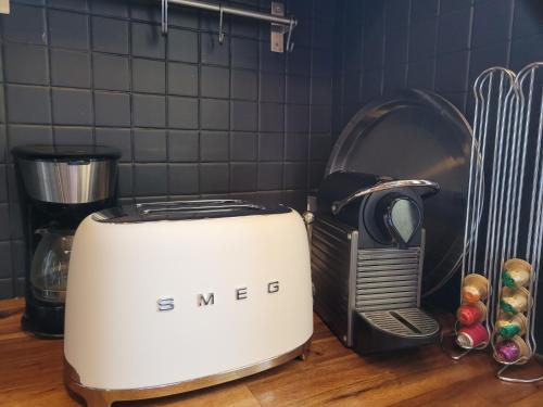 a toaster sitting on top of a kitchen counter at PARKING PRIVE -LE VALENTIN -Coeur Historique -La Clef de Honfleur in Honfleur