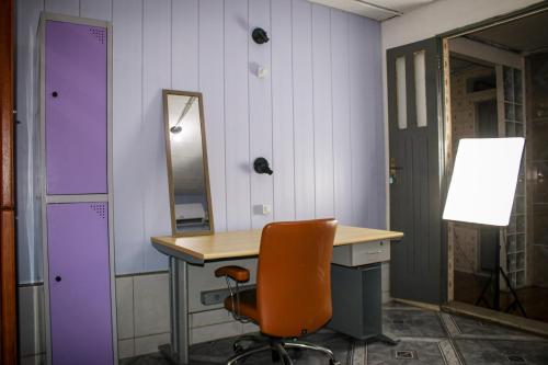 an office with a desk and a chair and a mirror at Aldeia Hostel in Manaus