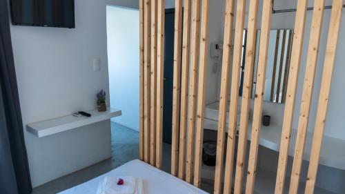 a bathroom with wooden walls and a white sink at Vista Mare in Naousa