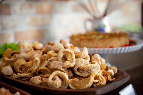 a pile of calamari on a wooden plate at Hotel Fazenda Vale da Cachoeira in Serra Negra