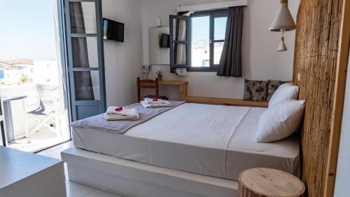 a bedroom with a bed with towels on it at Vista Mare in Naousa