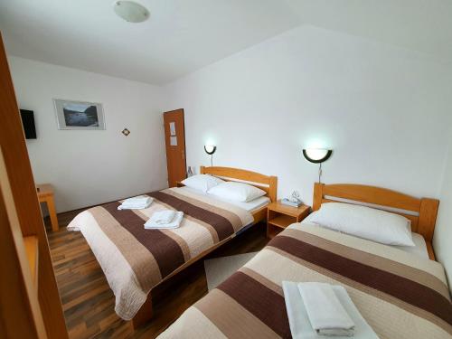 a hotel room with two beds in a room at Guesthouse Kovačević in Korenica