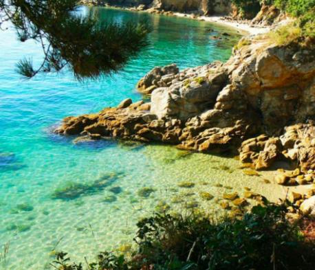 a body of water next to a rocky beach at Concarneau centre-ville proche plage in Concarneau