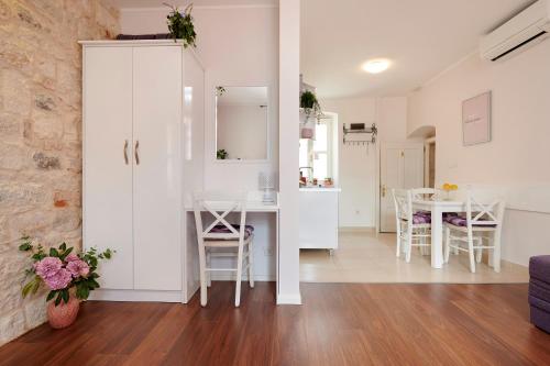 a kitchen and living room with a table and chairs at Palace Central Square in Trogir