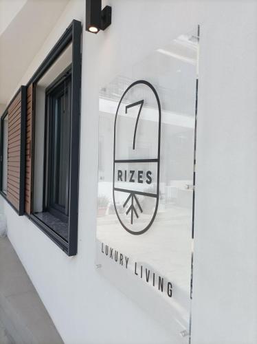 a sign on the side of a building with a window at 7Rizes Luxury Living in Heraklio Town