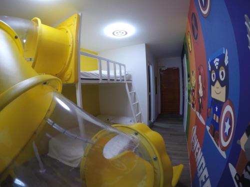 CoCo Guesthouse Kemaman في Cukai: غرفة مع سرير بطابقين وغرفة مع سرير بطابقين
