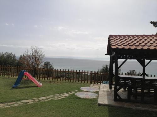 a playground with a plastic slide and a play structure at 2SEA LOFT NEA POTIDEA Chalkidiki in Nea Potidaea