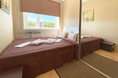 a bedroom with a large bed and a mirror at Mandarin Restoran & Hostel in Haapsalu