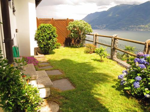 a garden with a view of the water at Brilago 1 in Brissago