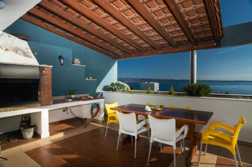 a dining room with a table and yellow chairs at Apartment Horizon in Split