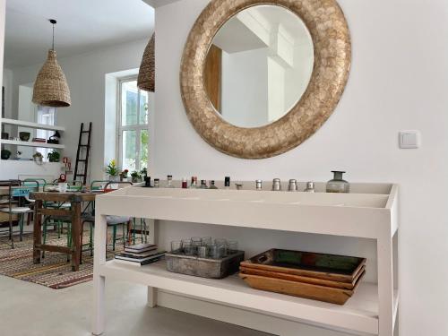 a bathroom with a sink and a mirror on the wall at Cedros Nature House in Sintra