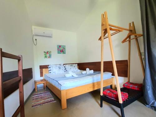 a bedroom with a bed with a swing at House & Yard Sesil M 110m to beach in Ureki