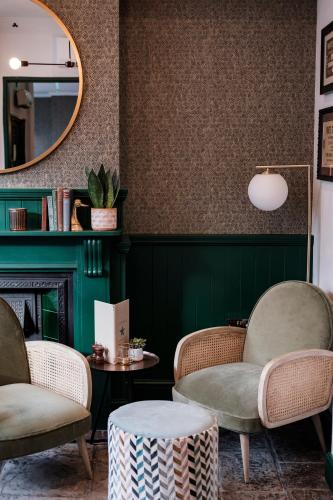 a room with two chairs and a table and a mirror at The White Star Tavern in Southampton