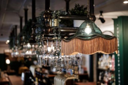 a chandelier hanging in a bar with glasses at The White Star Tavern in Southampton