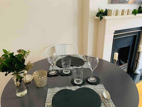 a black table with wine glasses on top of it at Luxury Fulham Flat with 5* touches nr River Thames in London