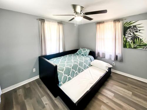 a bedroom with a bed and a ceiling fan at Sarasota Modern, Spacious, Comfy, Queen Beds, Backyard Rental in Sarasota